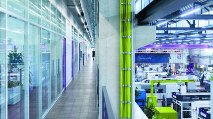 Production hall of vacuum technology supplier. On the right is the production hall. On the left is the long office corridor.
