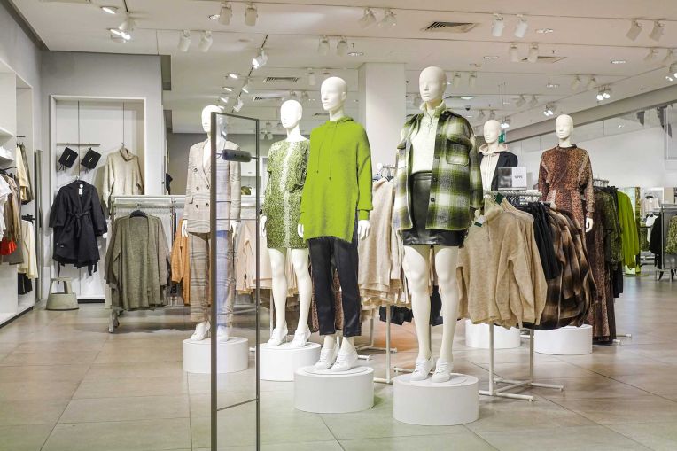View into a store with dressed mannequins